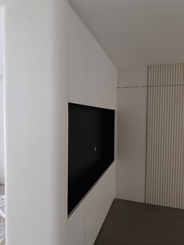 TV feature wall, near completion — real Chapter One Reno project photo, Kuching